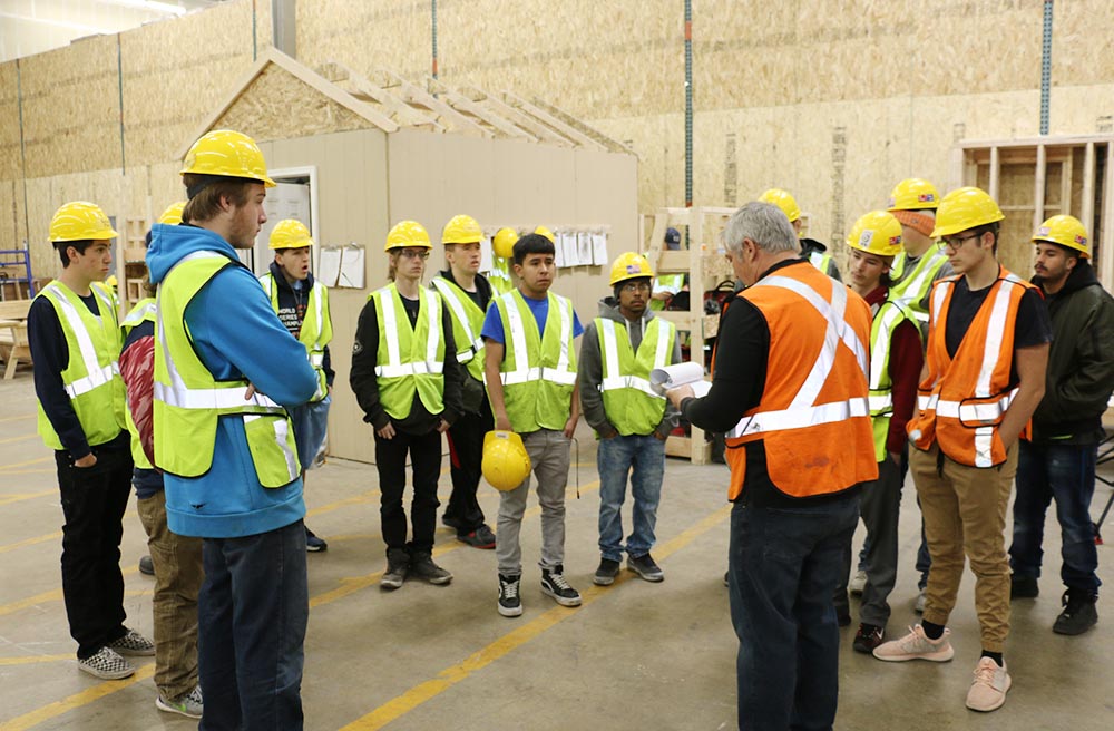 Instructor, Mark Babcock, leading a team meeting with youth apprentices (April 2018)