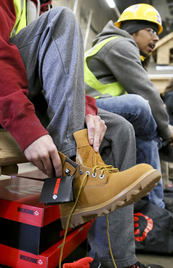 Youth Construction Program students try on Wolverine boots